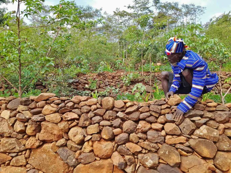 An Ethiopian farmer checks farm terraces